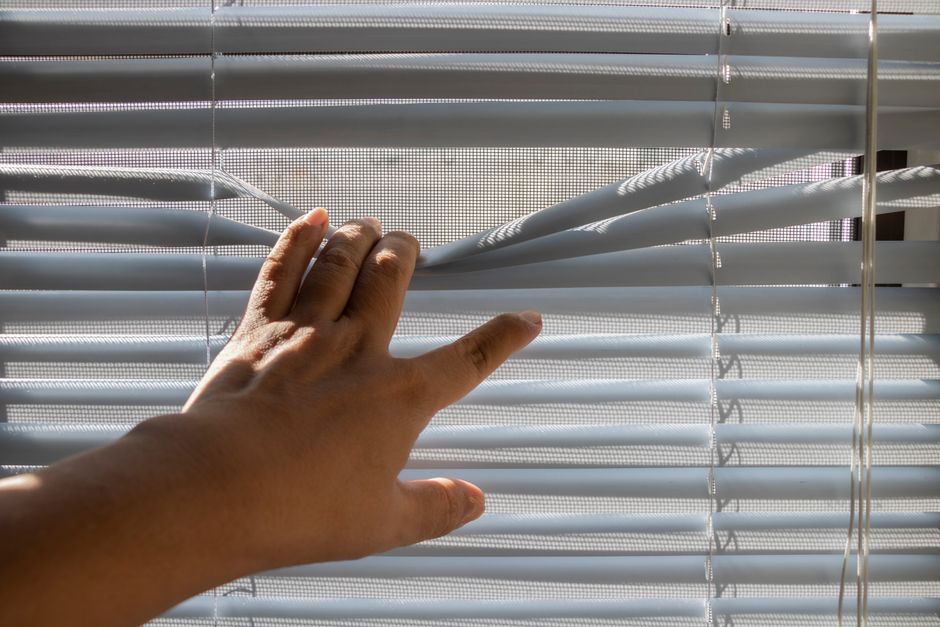 Interior designer adjusting custom window shades